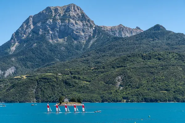 Lake of Serre-Poncon during summer is a popular destination for windsurf and outdoor activities, Hautes-Alpes, France
