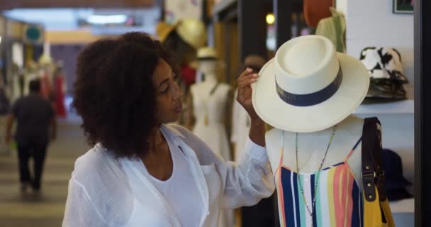 Young Pretty African American Woman Shopaholic Inspecting Stylish Straw Hat — 비디오