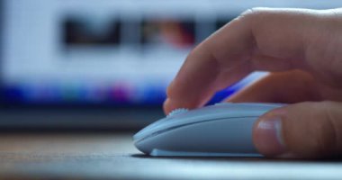 Scrolling internet websites online using computer mouse. Close up of male hand using mice to working at laptop