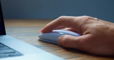 Angry man click mouse on frozen laptop computer, slam fist on table with fury, dissatisfied poor internet connection. Aggressive man click mice and show aggression while working at computer, close up