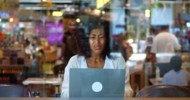 African American charming business woman freelancer entrepreneur failing her new business project or tender while working on laptop from cafe, expressing sadness and disappointment, feeling desperate