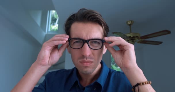 Portrait Young Man Years Old Blue Shirt Puts Glasses See — Stockvideo
