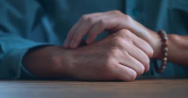 Close-up, an angry man hits the table with his fist, the concept of toughness and cruelty. Angry man beats with his fist the desk, aggressive male behavior. Emotional breakdown. 