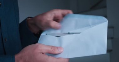 Close-up male hands counting money cash dollars taking them out of envelope. Concept salary in envelope laundering dirty money. Business person counting 100 dollar bills and putting them envelope.
