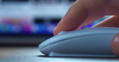 Male hand using computer mouse for working at computer. Scrolling internet websites online using roller of computer mouse. Close up of male hand using mice to working at laptop