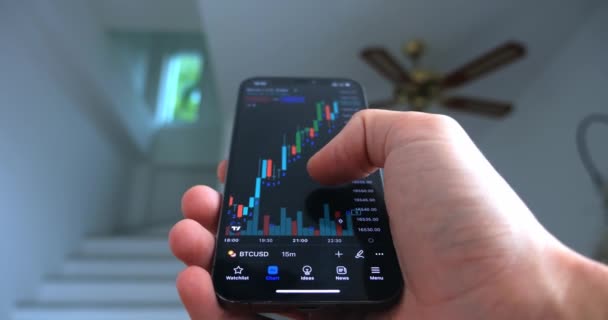 Crypto Enthusiast Using Smartphone App Analyzing Financial Data Stock Market — Vídeo de stock