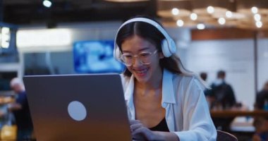 Young successful asian woman celebrate victory triumph look laptop winning lottery bid using computer at cafe working distantly. Lucky smiling asian woman freelancer with laptop celebrate great news.