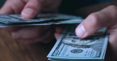Close up male hands counting money dollar cash. Unrecognizable man calculating 100 us dollar banknotes income. Money profit concept. Business person counts earning money.
