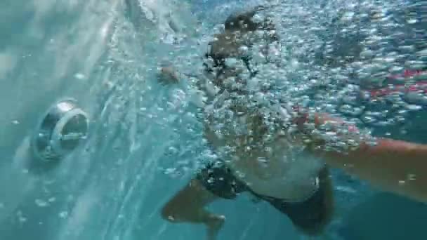 享受夏天的活动拍摄的动作相机 在豪华酒店度过暑假的时候 戴着太阳镜的Pov年轻人潜入游泳池拍摄自己的照片 游客喜欢在游泳池里放松一下 Pov Shot — 图库视频影像