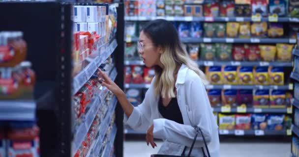Молода Азіатка Споживачка Окулярах Дивиться Високі Ціни Їжу Продуктовому Магазині — стокове відео