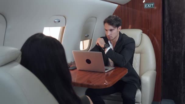 Elegantly dressed man works on laptop during luxurious flight work on laptop sign of successful modern career. Achieving happiness and freedom through work on laptop high above the clouds