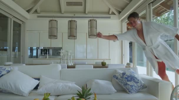 Living Room Man Exudes Joy Jumping Sofa Face Exuberance Pure — Stock Video