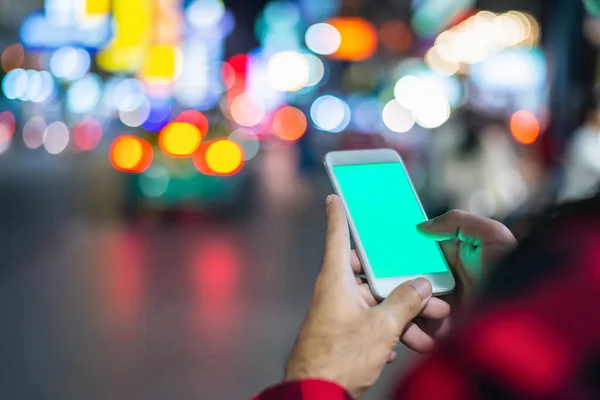 Roadside cell phone use by a traveler, with a nightlight Background