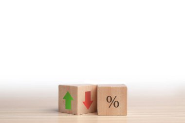 Icon for the percentage symbol on a cube. Concept of financial interest rates and mortgage rates. Change from down to up arrow on wood cube. Stocks, interest rate, and ranking. Concept of business.