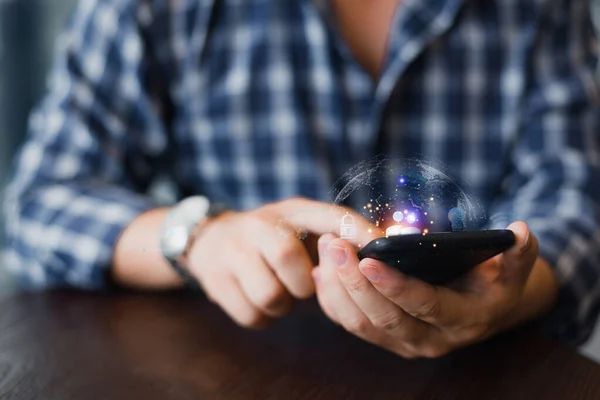 stock image Young Man using technology-based, creative, and communication concept while using a mobile smart phone with a global network connection.