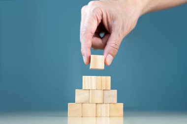 Kullanıcı giriş metni ve bir bilgi simgesi için kopyalama alanı olan boş tahta küpler elle yerleştirilir ve bir tablo üzerine istiflenir.