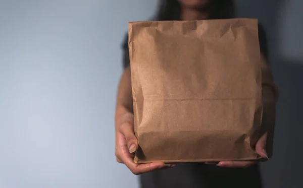 Close Unrecognizable Person Presenting Plain Brown Paper Bag Potential Branding — Stock Photo, Image