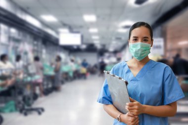 Maske takan ve hastane koğuşunda pano tutan kadın hemşire tıbbi bakım ve profesyonelliği vurguladı..