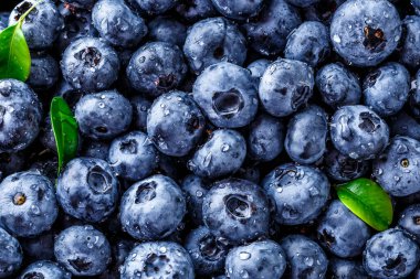 Olgun tatlı yaban mersinine su damlası. Metnin için fotokopi alanı olan taze yabanmersini arkaplanı. Vejetaryen ve vejetaryen kavramı. Yaban mersinli böğürtlenlerin makro dokusu. Yaban mersinli üzümlü.