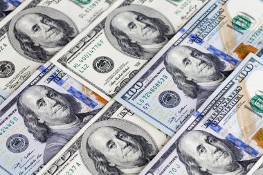 Money American yüz dolarlık banknotlar. Dolarlar arka planda. Çeşitli Amerikan banknotları. Masaya saçılmış Amerikan paraları.