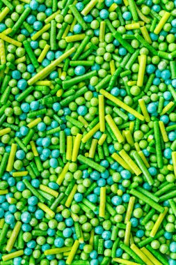 Şekerlemelerin dokusu, çeşitli şeker serpintileri, yıldızlar, çiçekler, noktalar. Bayram ikramı. Çörekler, çörekler, tatlılar ve dondurma. .