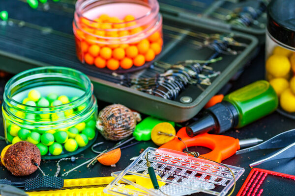 Carpfishing session at the Lake.fishing tools, scissors, carp bait,mixed in dips and stickbaits.Carp fishing rig.The Boilies with fishing hook.