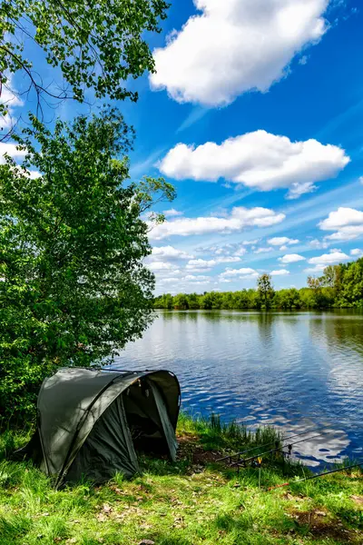 stock image Carpfishing session at the Lake.Carp Angling scenic landscape overlooking lake at and blue sky with clouds.Fishing adventures, carp fishing.