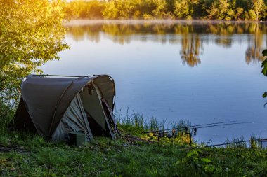 Gölde balık avı. Sazan balıkçılığı manzarası göl manzarası ve bulutlu mavi gökyüzü. Balıkçılık maceraları, sazan balığı avcılığı..