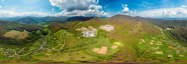 stock image Carpathian Mountains of Ukraine, a quarry where granite sandstone is mined for the production of building materials, powerful trucks and conveyors load gravel - video from a drone