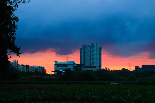 stock image Sunset on the outskirts of jakarta with plantations in the foreground