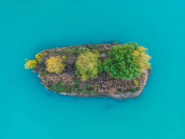 View of little islands on a turquoise lake. Landscape from the drone. Turquoise lakes, islands and green forests from above.