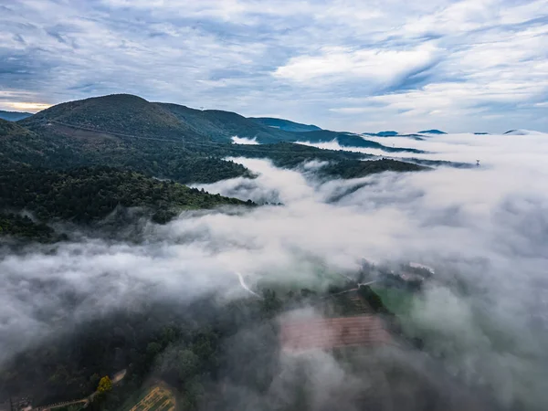 stock image Thick morning fog covering the valley between the surrounding mountains in southern France, autumn season