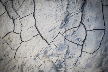 Cracked earth in the top view for the background or graphic design with the concept of drought and death.