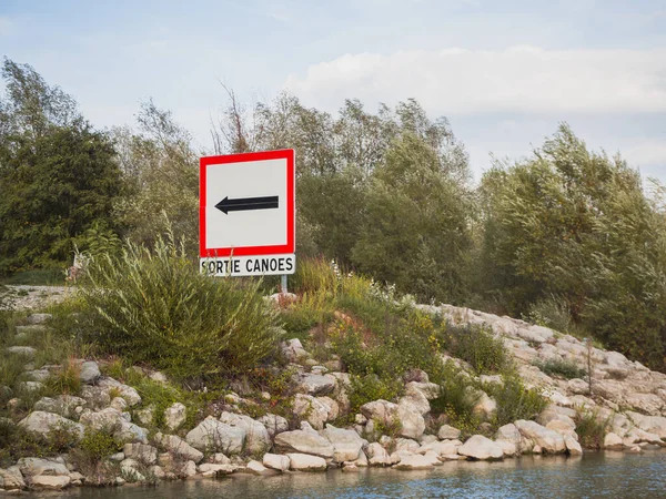 Exit sign for canoes on the river. \