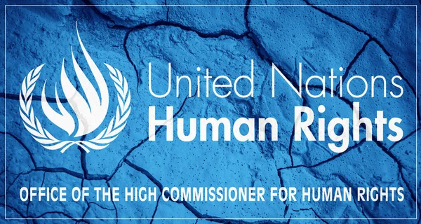 Flag of United Nations Human Rights Council. UNHR symbol. Flag on the background of dry cracked earth. United Nations flag with drought concept