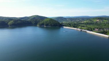 Günbatımında İHA 'nın panoramik görüntüsü Soliskie Gölü' nde Solina su barajının üstündeki gözetleme kulesine bakan modern teleferik vagonu Polonya 'nın Bieszczady Dağları' nda.