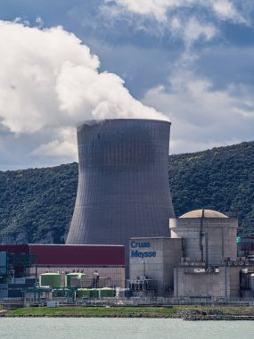 Cruas, Fransa - 4 Nisan 2023: Nükleer santral (CNPE Cruas-Meysse) üzerindeki nehir üzerinde arka plandaki kireçtaşı kayalarına bakın.