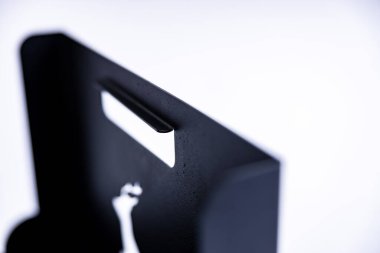 An empty metal box for firewood on white background in a studio photoshoot. A deer symbol cutout on the sides. High quality photo