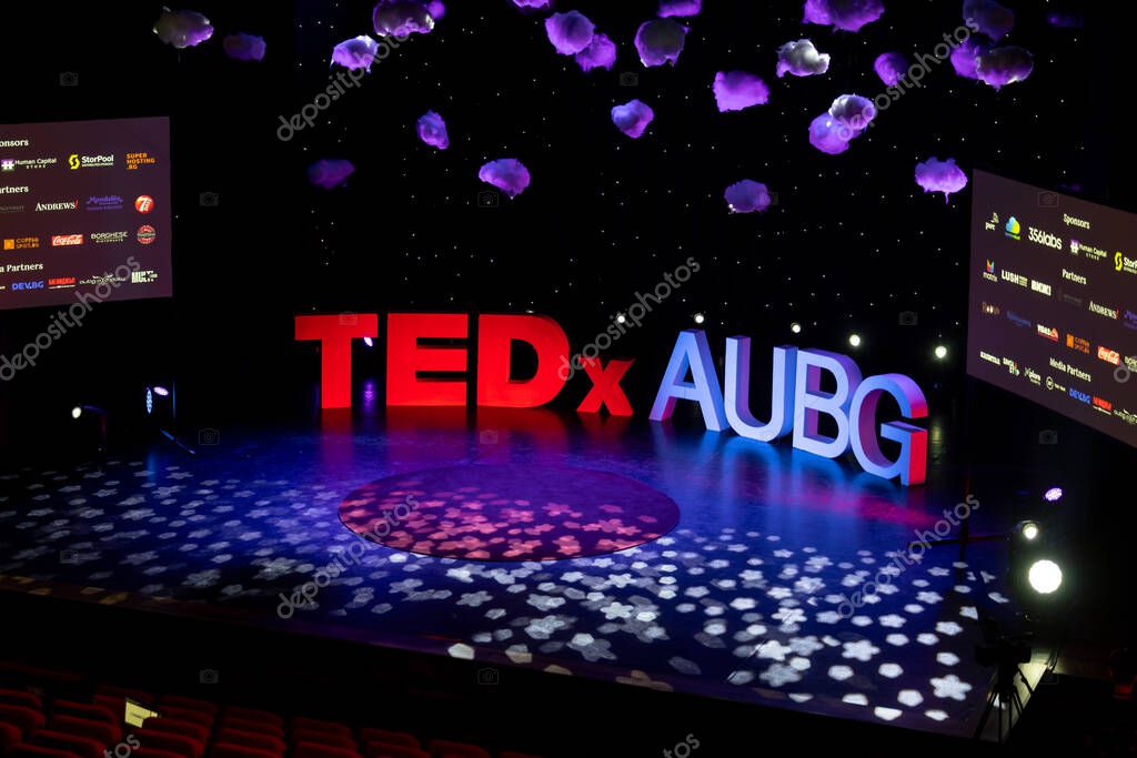 6 APRIL 2024, Blagoevgrad, Bulgaria: The TEDxAUBG conference letters on the stage. Screen shows sponsors. High quality photo. High quality photo