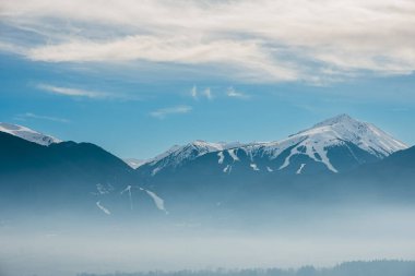 Pirin dağı, Bulgaristan. Kış kayak sezonunda karla kaplı. Dağın altında sis var. Mavi bulutlu gökyüzü. Yüksek kalite fotoğraf