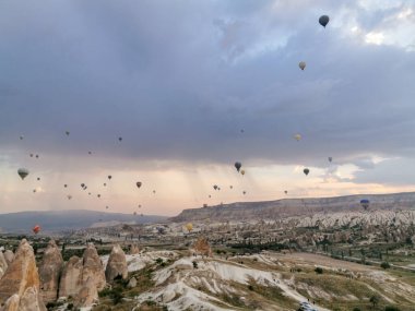 Güneş doğarken sıcak hava balonları kapadokçaların üzerinde eşsiz bir manzara