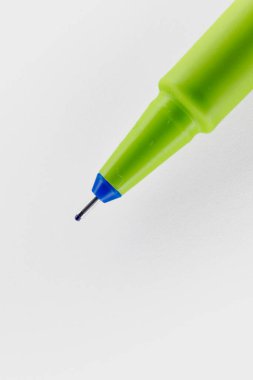 Close-Up of a Green Ballpoint Pen Tip on White Surface clipart