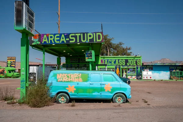 stock image Arizona, Usa, September 16,2022. Blue Retro Camper Van With Floral Designs Parked At Modern Gas Station With Area Stupid Text During Summer