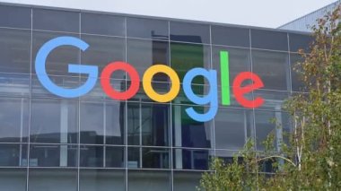 Detail shot of global internet search engine company Google office with multi colored logotype on glass wall. Google logo.