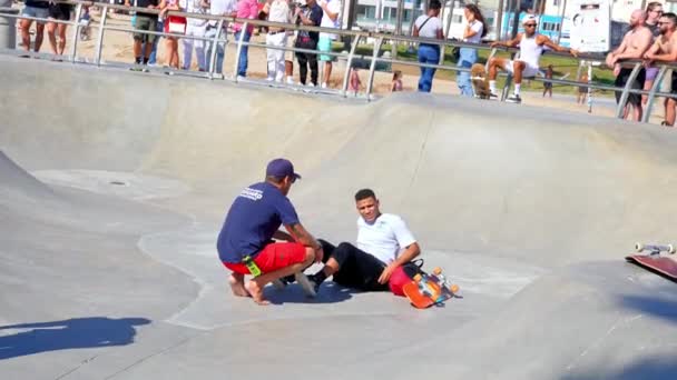 Firefighters Lifeguards Examining Injured Man Ramp Skateboard Park While People — Stockvideo