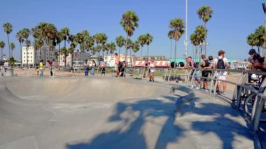 Skateboarder at the skatepark in Venice Beach, CA. People skating at the beach. This 16,000 sq. foot skatepark is one of the only in the world located on a beach.