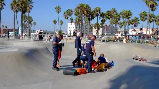 Firefighters Lifeguards Examining Injured Man Ramp Skateboard Park While People — 图库视频影像