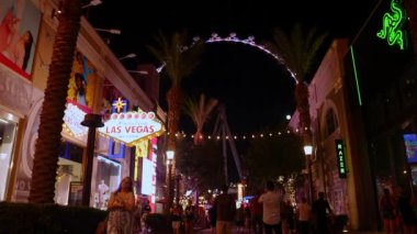 The High Roller observation wheel 4k video. It illuminates as dusk sets on the Las Vegas strip and valley beyond. 