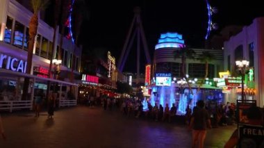 The High Roller observation wheel 4k video. It illuminates as dusk sets on the Las Vegas strip and valley beyond. 