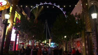 The High Roller observation wheel 4k video. It illuminates as dusk sets on the Las Vegas strip and valley beyond. 